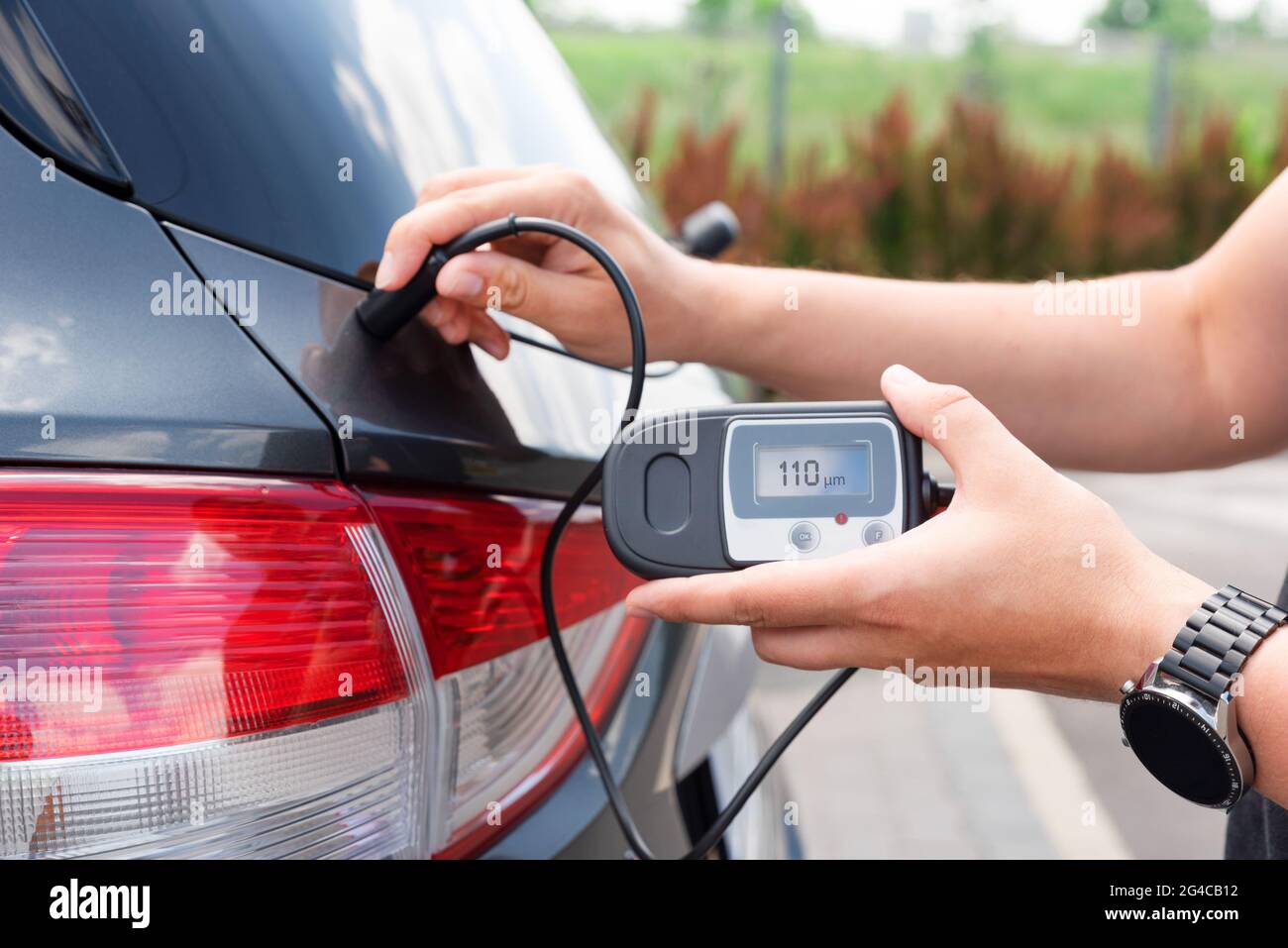 Measuring thickness of the car paint coating with paint thickness gauge Stock Photo