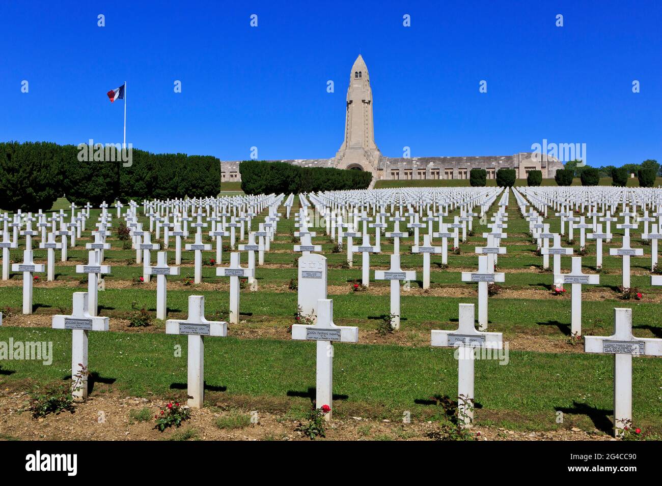 The French flag flying proudly over the WWI Douaumont Ossuary & Fleury-devant-Douaumont National Necropolis in Douaumont-Vaux (Meuse), France Stock Photo