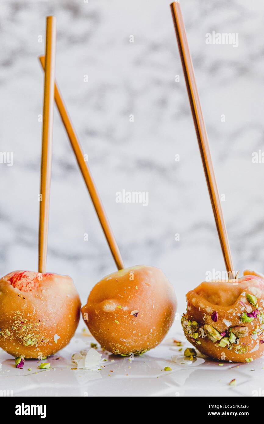 Caramel, Toffee Apples on sticks, light and bright white background