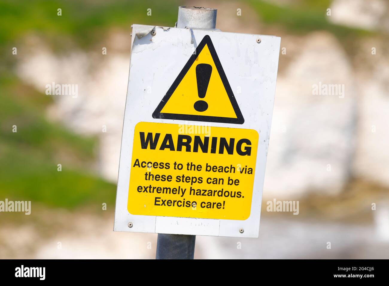 A warning sign to pedestrians who wish to descend to a beach at Selwick Bay from cliff tops in Flamborough,East Yorkshire,UK Stock Photo