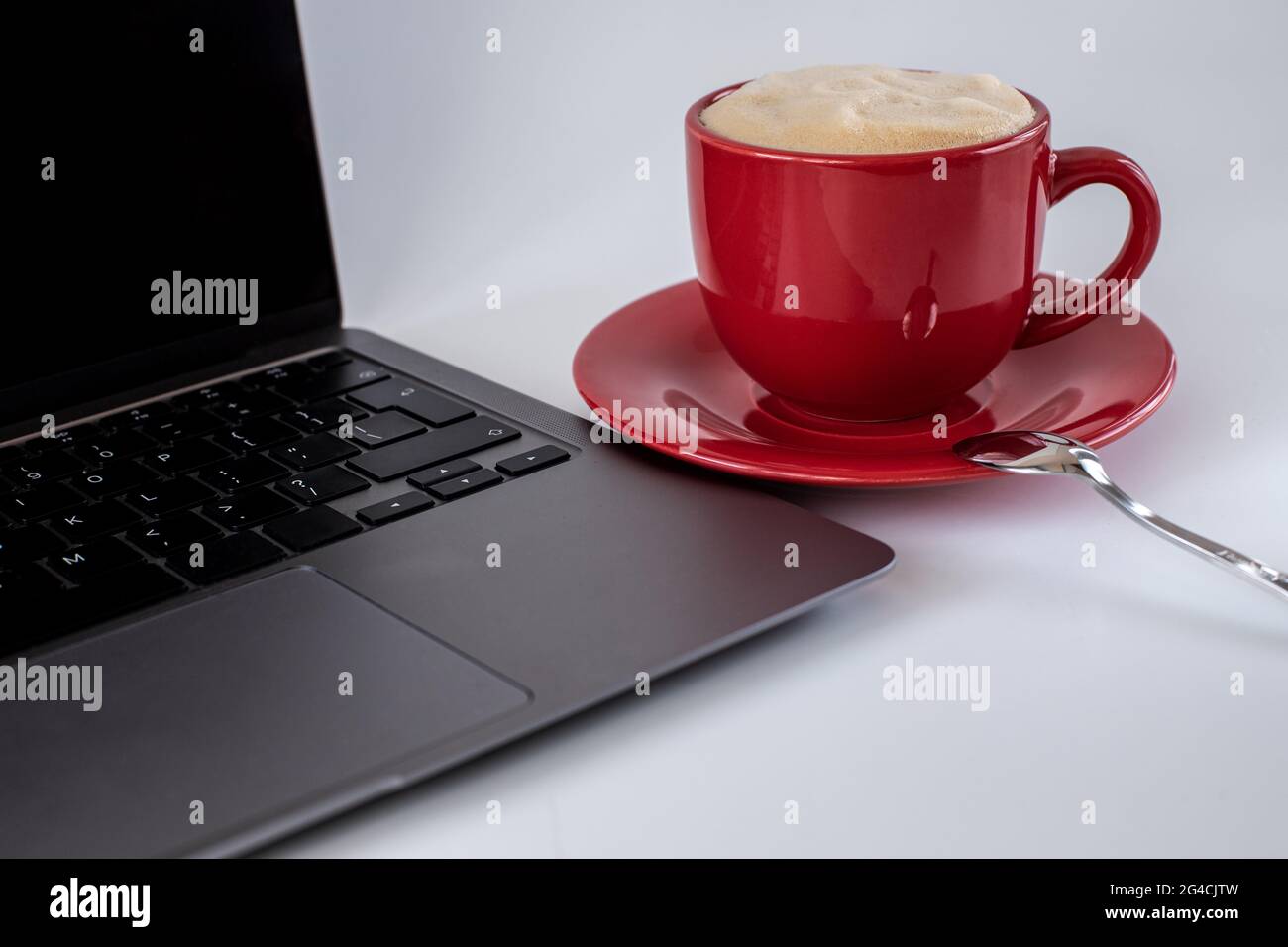 A cup of coffee and a laptop computer are on the table. Selective focus Stock Photo