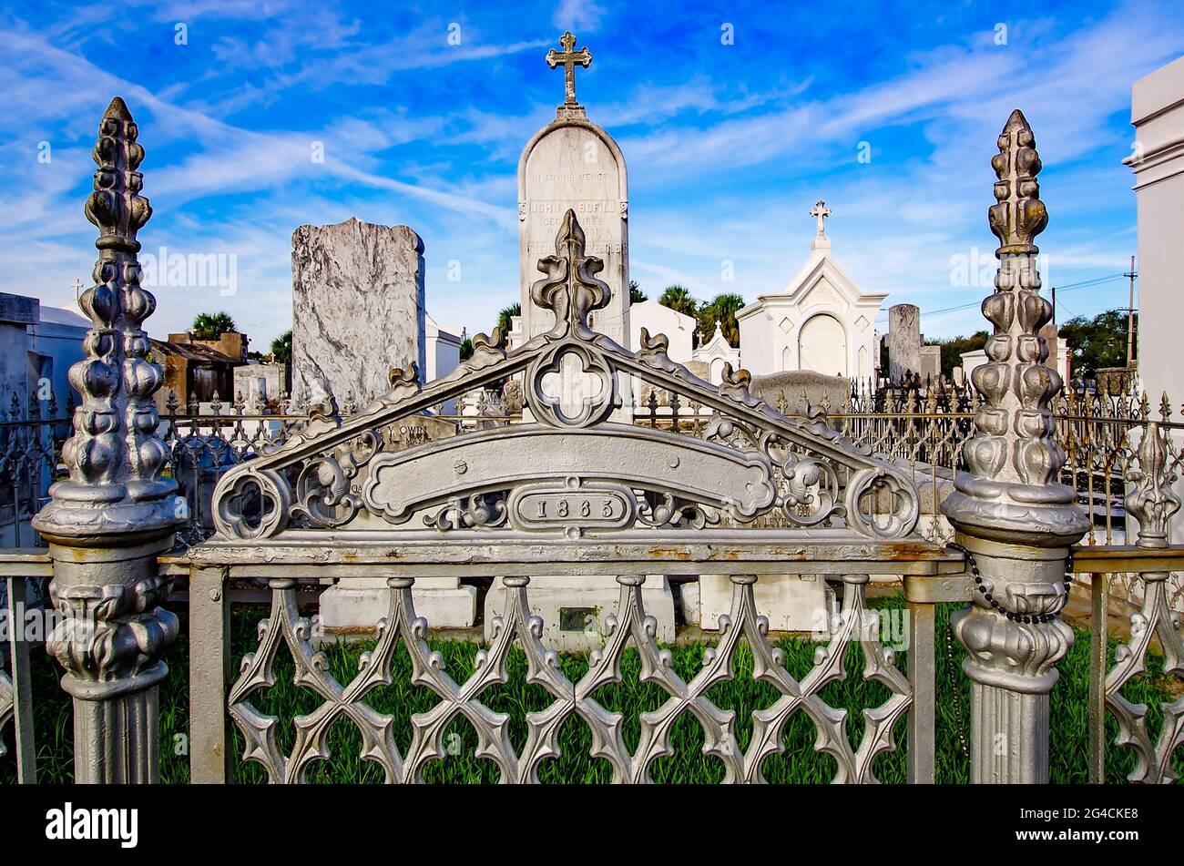 above-ground-graves-and-family-tombs-are-pictured-behind-a-wrought-iron