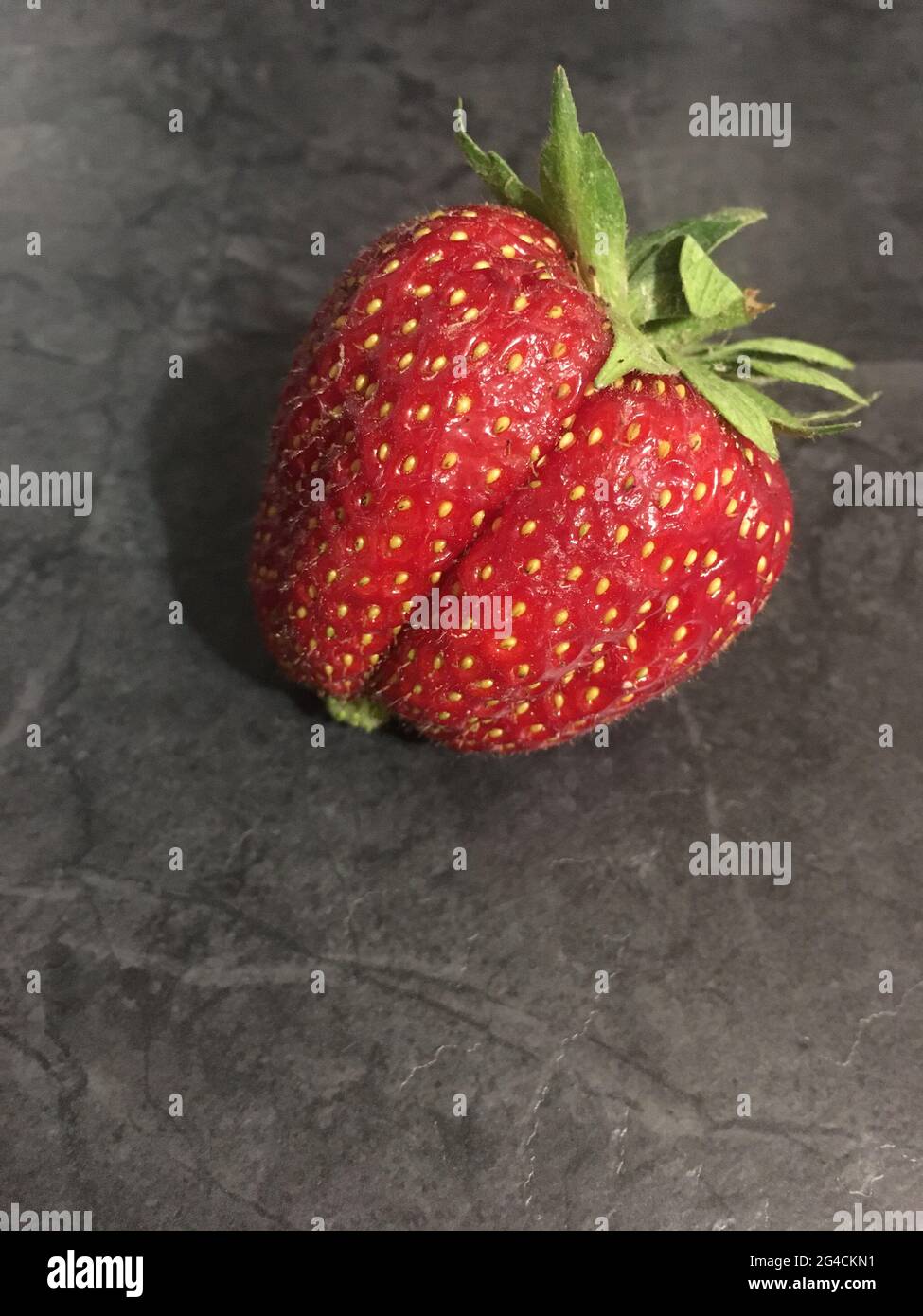 Red ripe strawberry berry on black background Stock Photo - Alamy