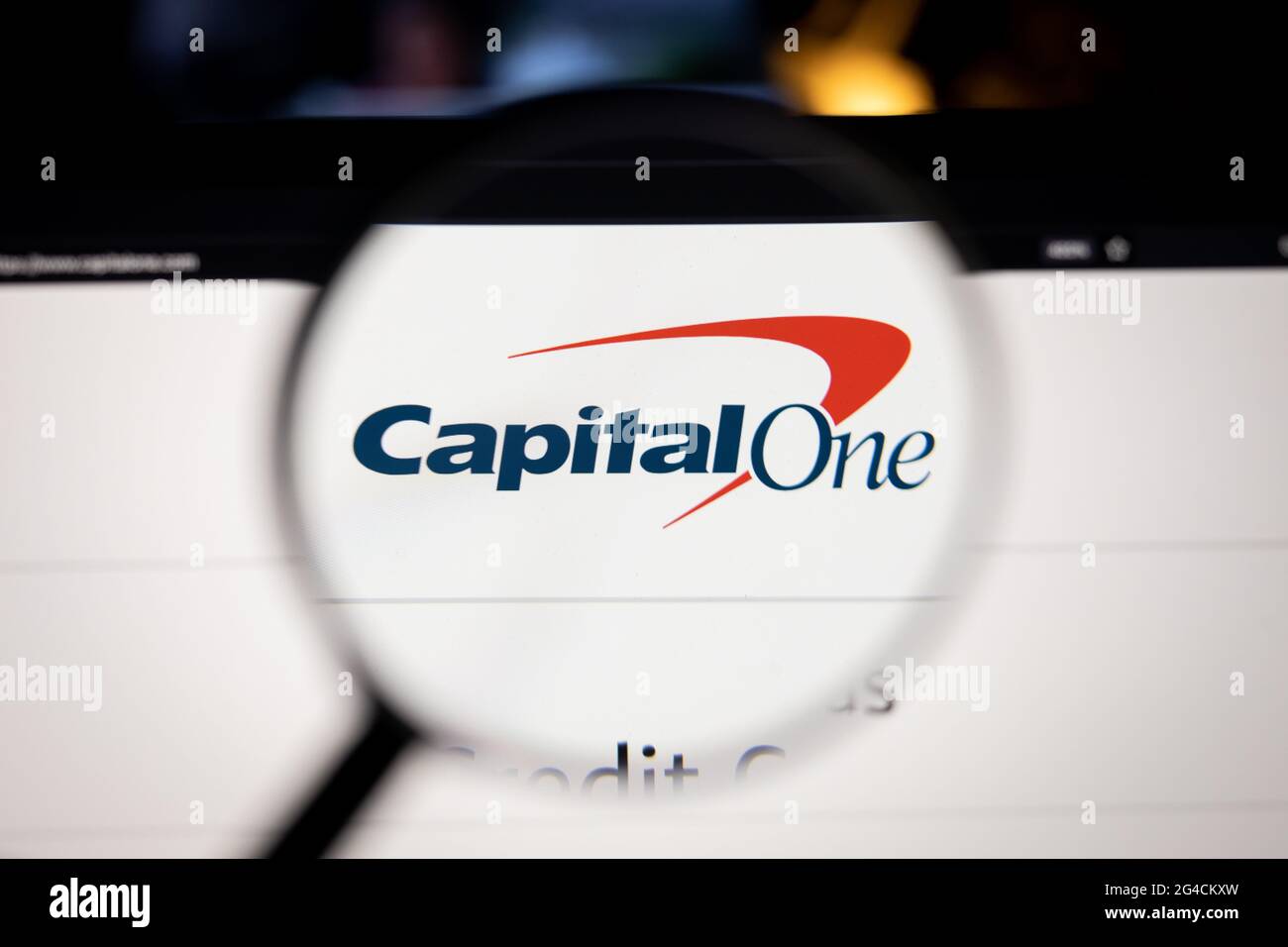 Capital One company logo on a website, seen on a computer screen through a magnifying glass. Stock Photo