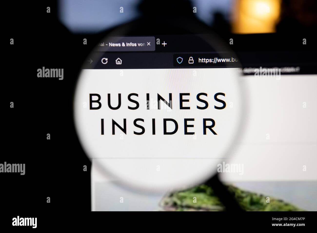 Business Insider company logo on a website, seen on a computer screen through a magnifying glass. Stock Photo