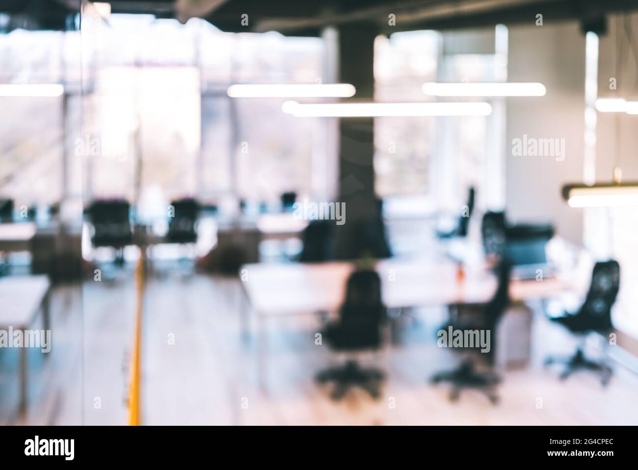 Blurred modern coworking office with no people as a remote working and social distancing concept. Abstract defocused background, space for text copy Stock Photo