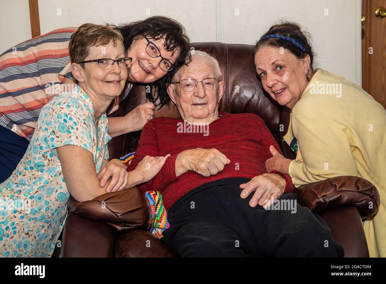 Three sisters with their 97 year old father. Stock Photo