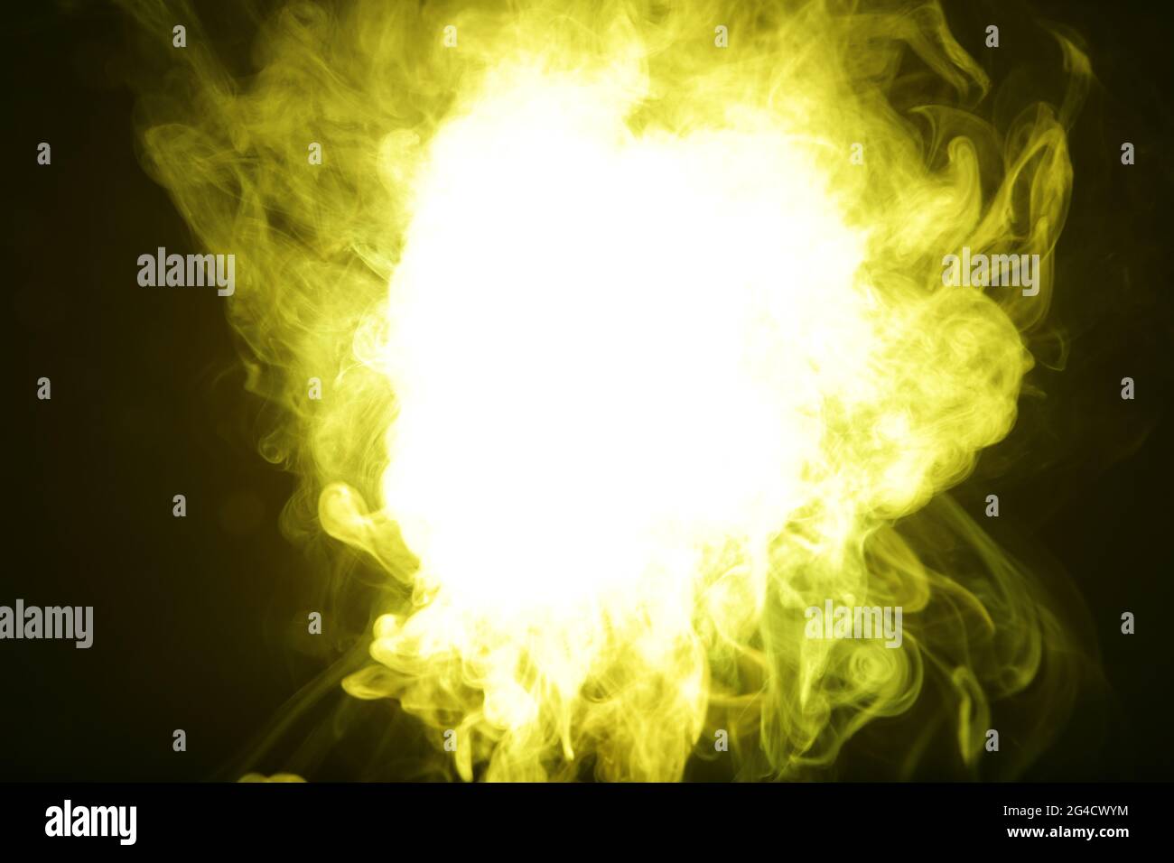 Artificial yellow light illuminates smoke on dark background Stock
