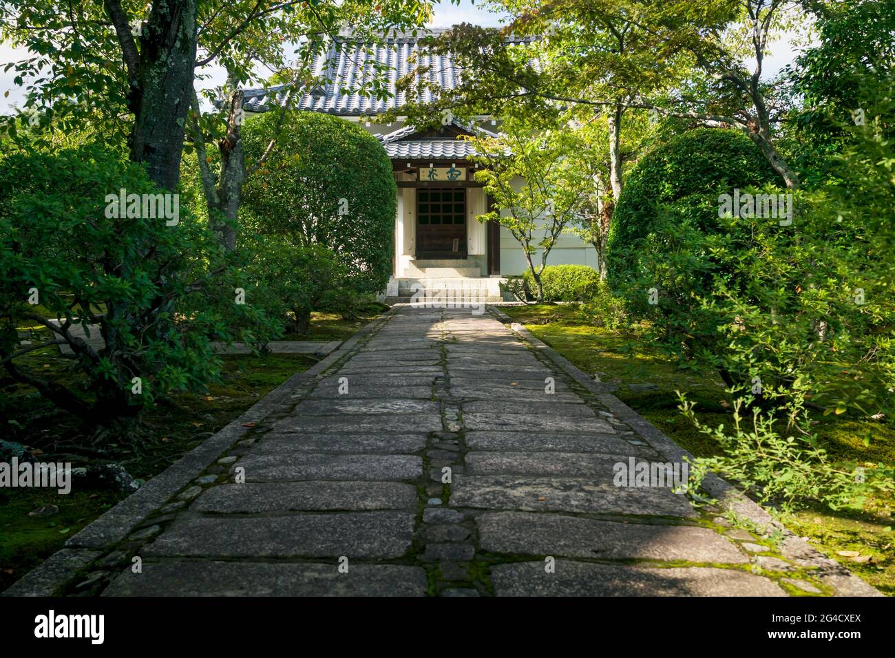Kyoto, Japan - 18 September 2017: Path surrounded by trees to temple building in Sogenchi garden at Tenryu-ji Stock Photo
