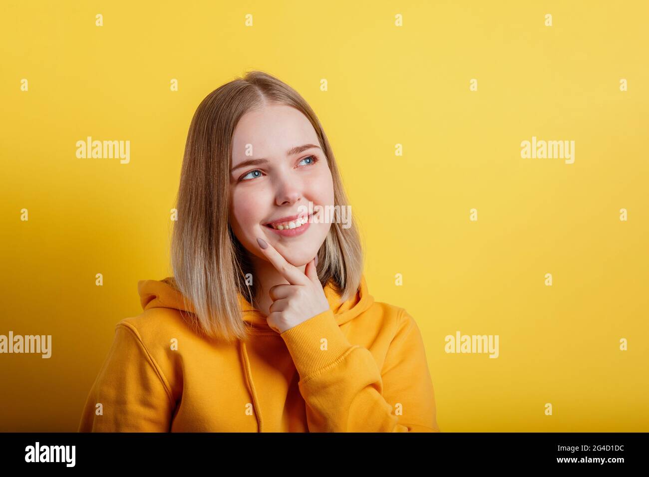 Happy smiling young woman think thought. Portrait of emotional teenage girl looking on empty space deep thinking about idea or positive question on Stock Photo