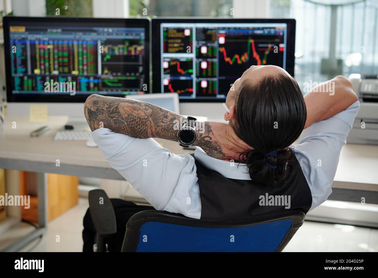 Happy successful trader relaxing in his armchair after having lucky day