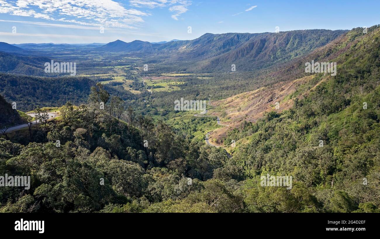 Aerial of valley between mountain ranges under a cloudy blue sky Stock ...