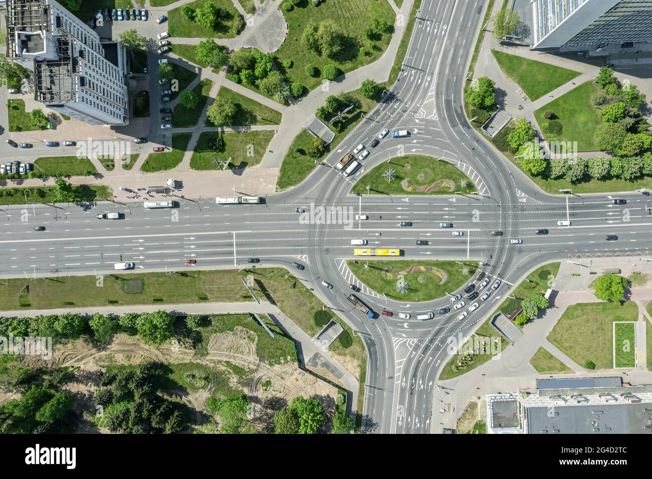 aerial top view of roundabout road with cars traffic in city at summer afternoon Stock Photo