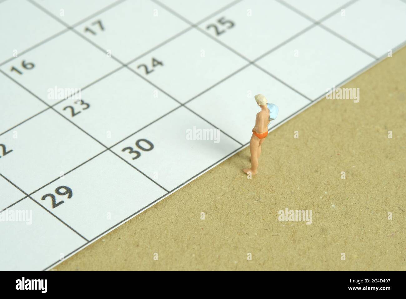 Miniature people toy figure photography. Travel plan schedule concept, men standing in front of calendar. Image photo Stock Photo