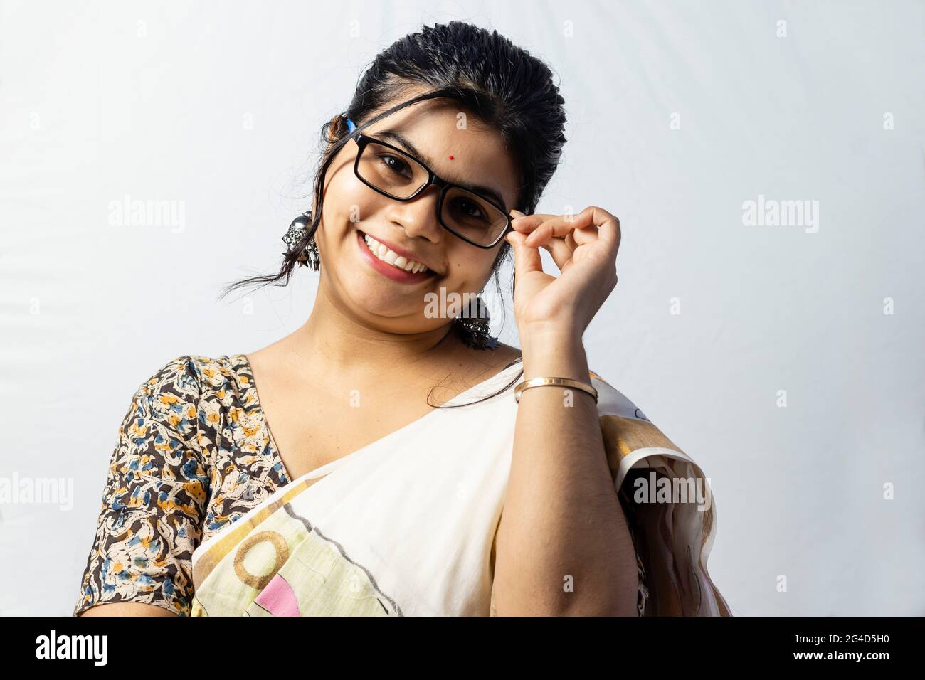Isolated on white background an Indian office woman in saree posing with her eyeglasses Stock Photo