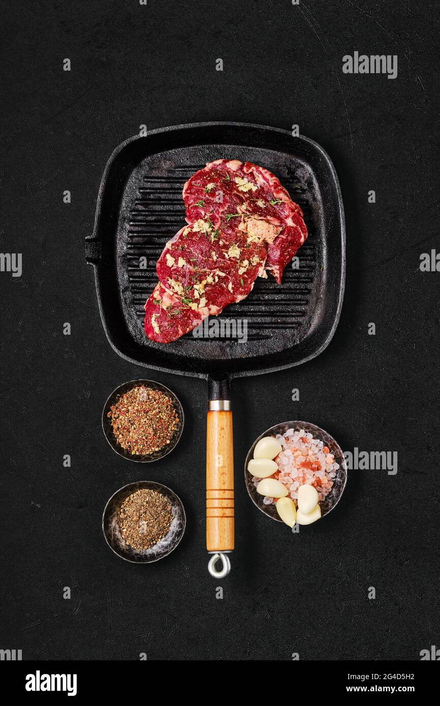 Preparation of ribeye steak in cast iron skillet Stock Photo Alamy