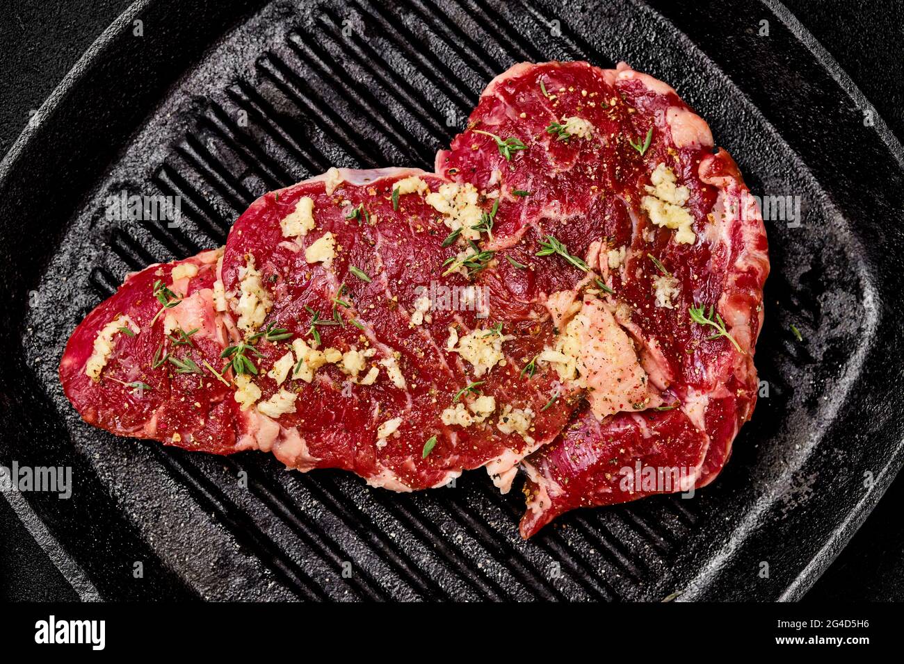 Preparation of ribeye steak in cast iron skillet Stock Photo Alamy