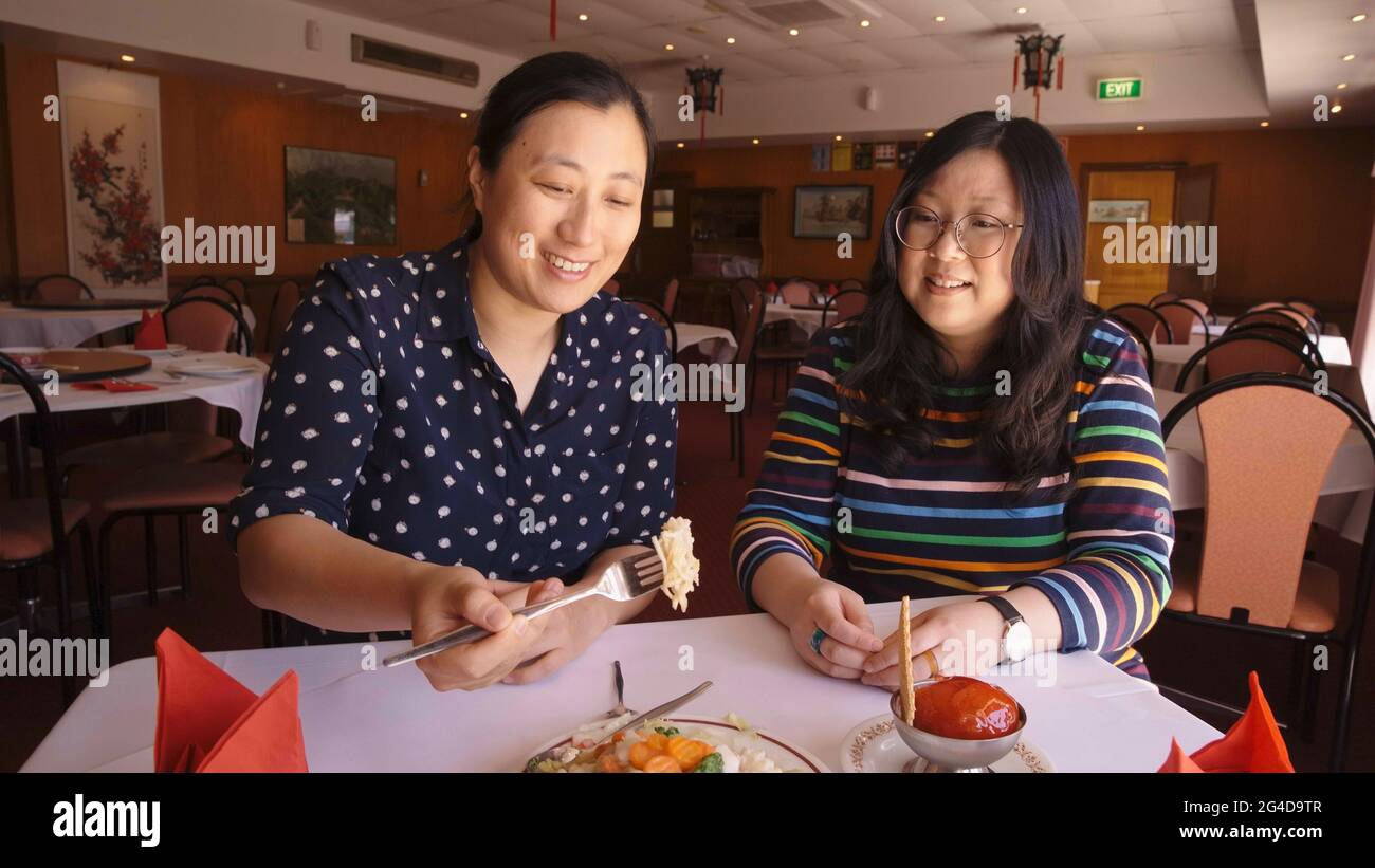 Sydney. 21st June, 2021. Lin Jie Kong (L), director of 'Chopsticks or Fork?', and Jennifer Wong, hostess of the program, sample a dish at the New Bo Wa Restaurant in Moree in northern New South Wales, Australia, on Oct. 21, 2020. TO GO WITH 'Feature: Chinese-Australian entertainer's TV program lovingly looks at life's sweet, sour moments' Credit: Xinhua/Alamy Live News Stock Photo