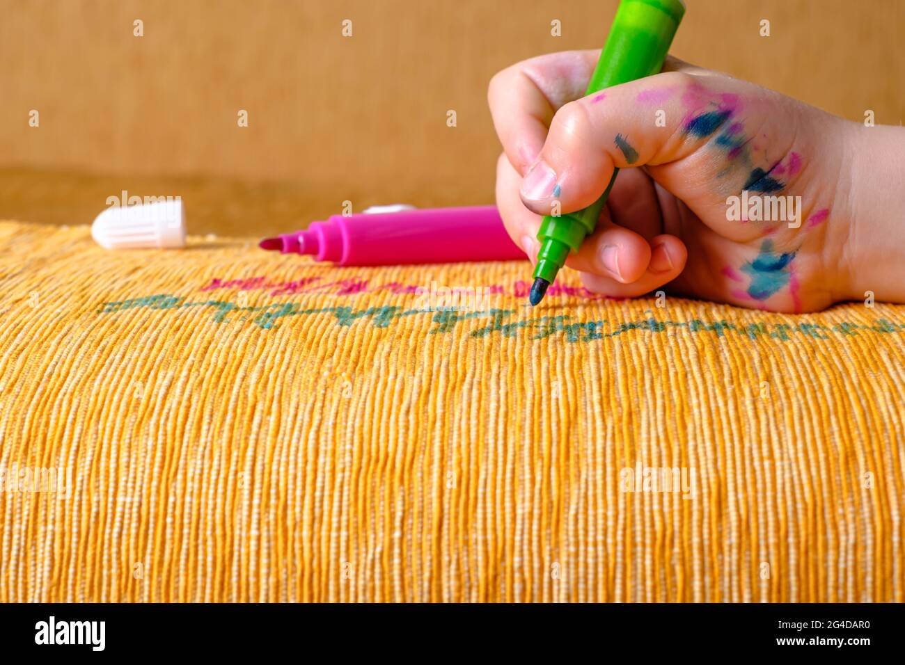 Dirty children's hand in colored markers draws with a green felt-tip pen of  the couch. daily life dirty stain for wash and clean concept Stock Photo -  Alamy