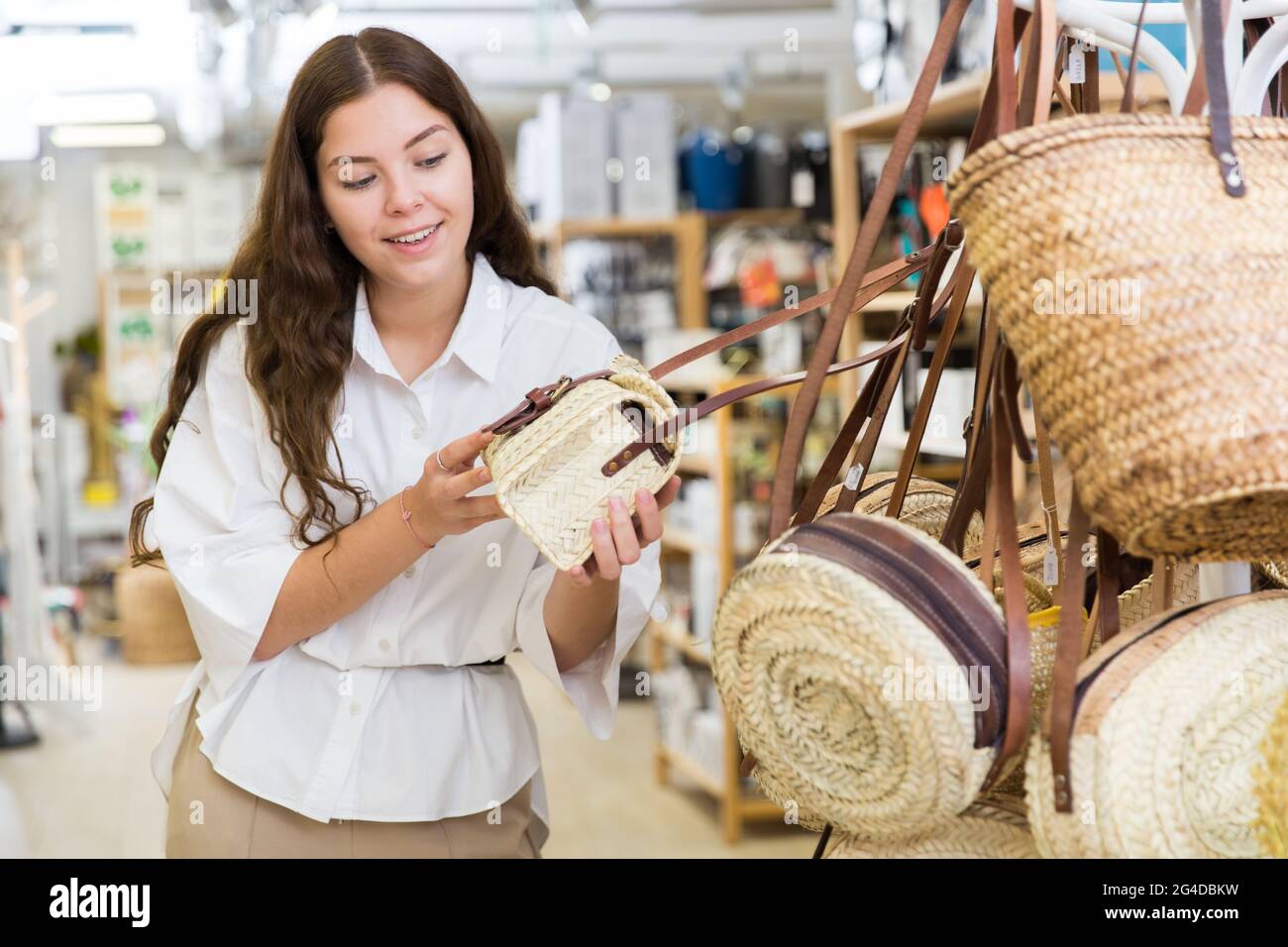 Woman buying straw bag at hardware store Stock Photo Alamy