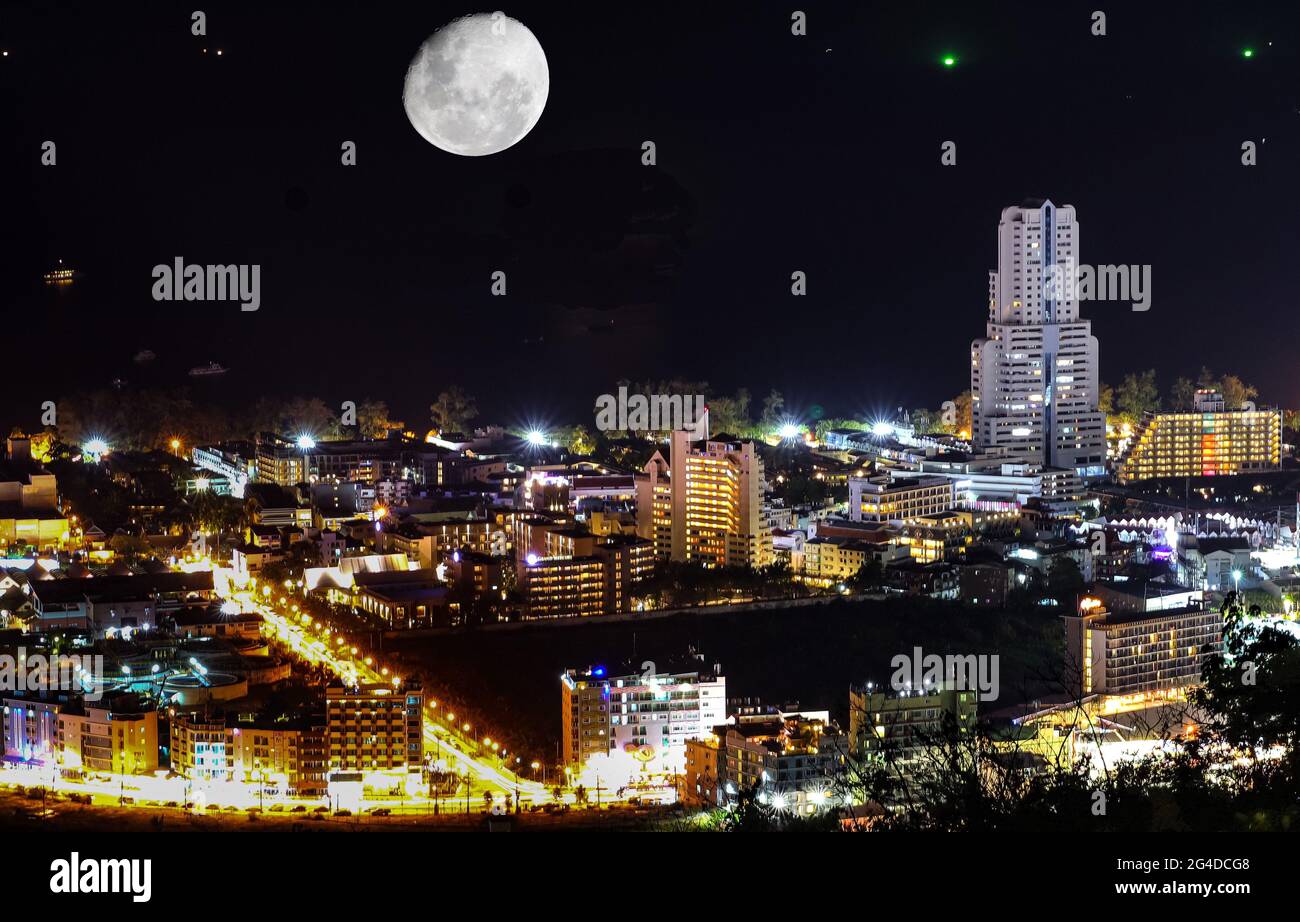 Night panorama view of Patong beach Phuket Thailand. Beautiful lights shining on the bay from the resorts and hotels. Smooth clear waters. Neon Lights Stock Photo