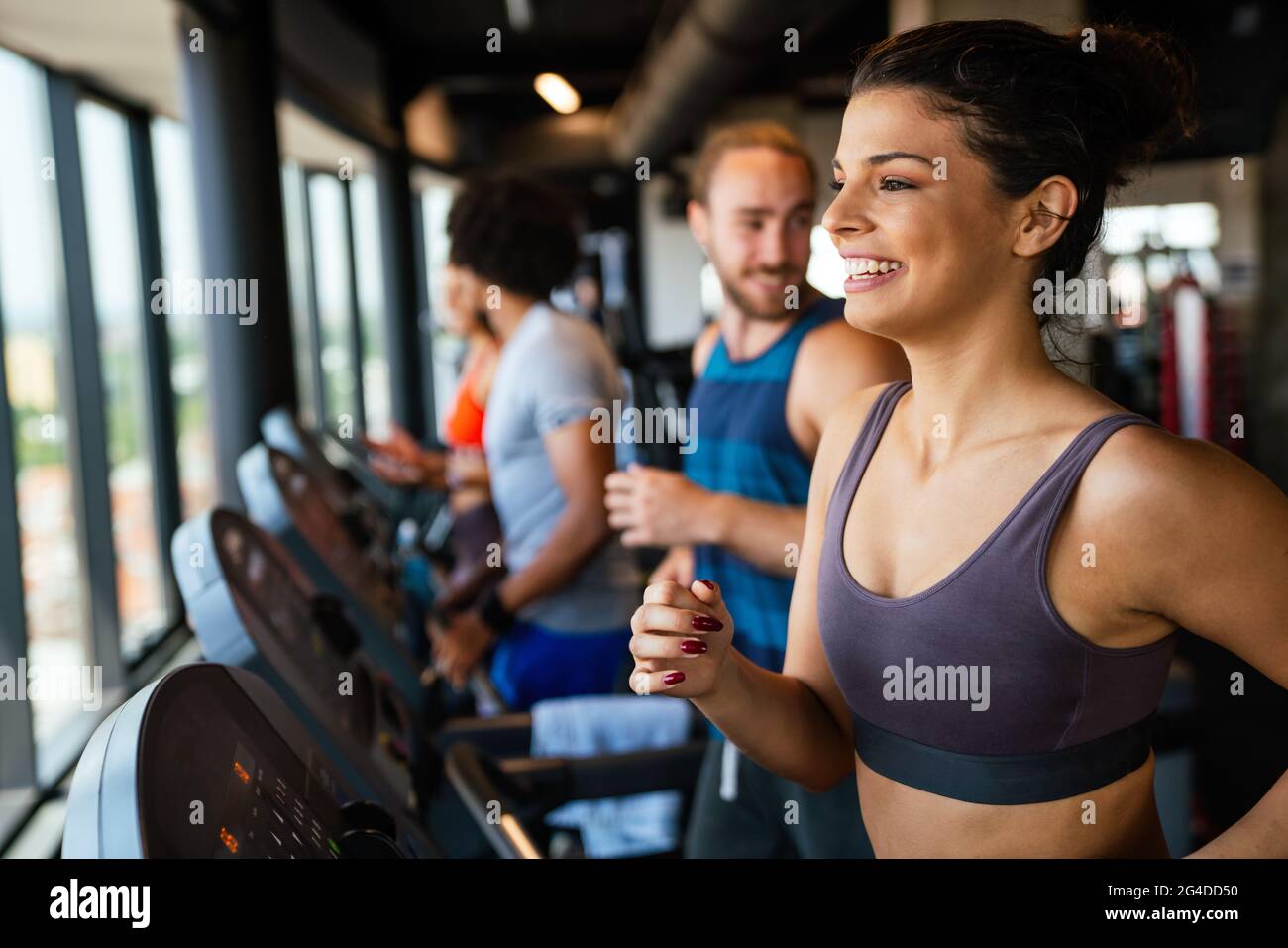 Group of young people running on treadmills in sport gym Stock Photo ...