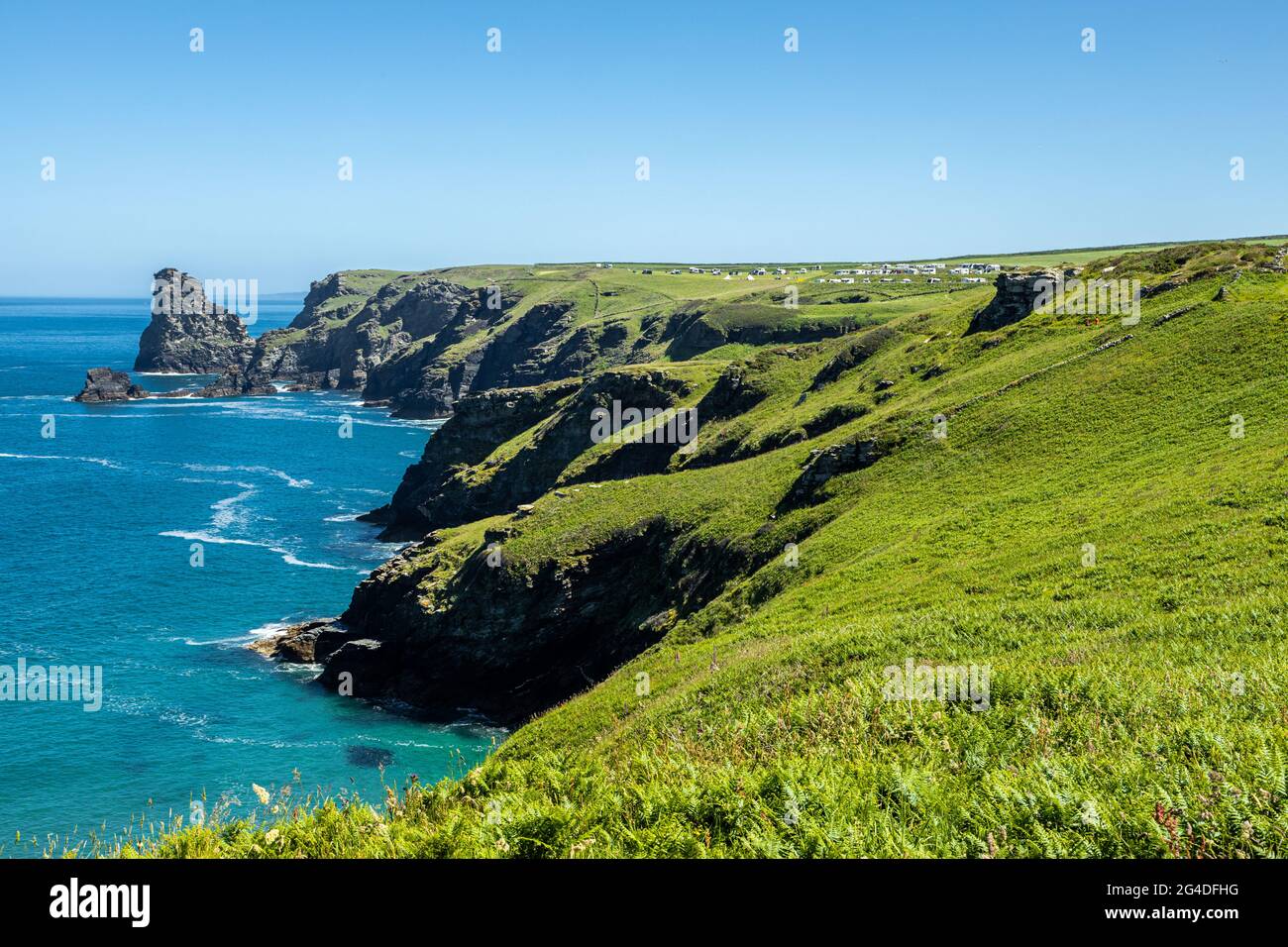 The beautiful English coastline with lush green pastures sparkles in the summer sunshine   Bossiney Tintagel Cornwall England UK Stock Photo