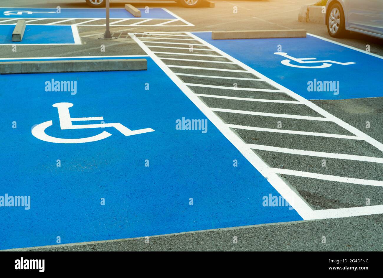 Asphalt car parking lot reserved for handicapped driver in supermarket or shopping mall. Car parking space for disabled people. Wheelchair sign paint Stock Photo