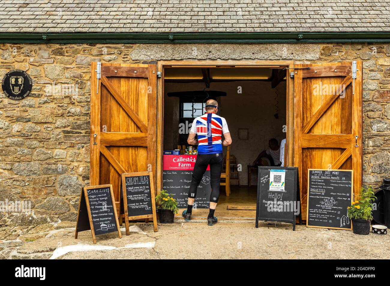 A cyclist stops for a break at a well known cafe eatery close to St Agnes Cornwall England UK Stock Photo