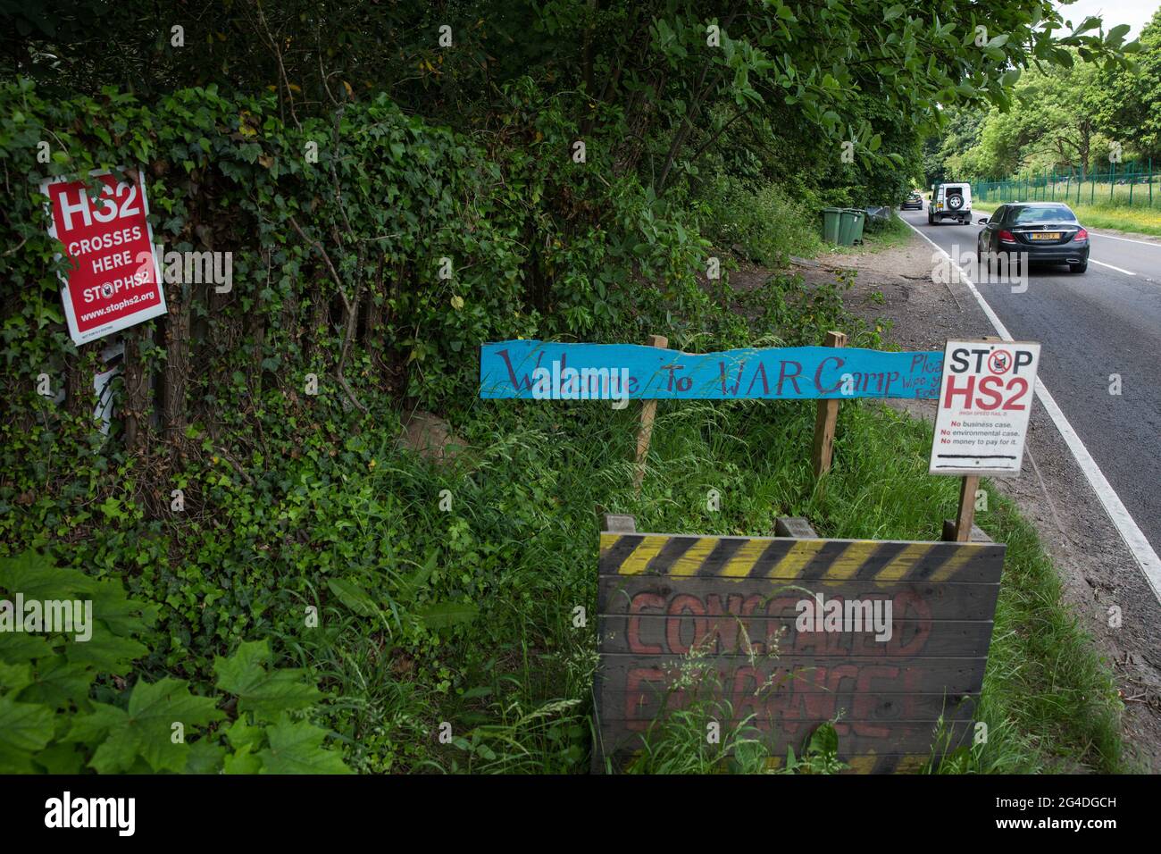 Wendover, UK. 16th June, 2021. Signs alongside the A413 outside Stop HS2's Wendover Active Resistance Camp. Large areas of land around Wendover in the Chilterns AONB have already been cleared of trees and vegetation for the HS2 rail infrastructure project in spite of concerted opposition from local residents and environmental activists. Credit: Mark Kerrison/Alamy Live News Stock Photo