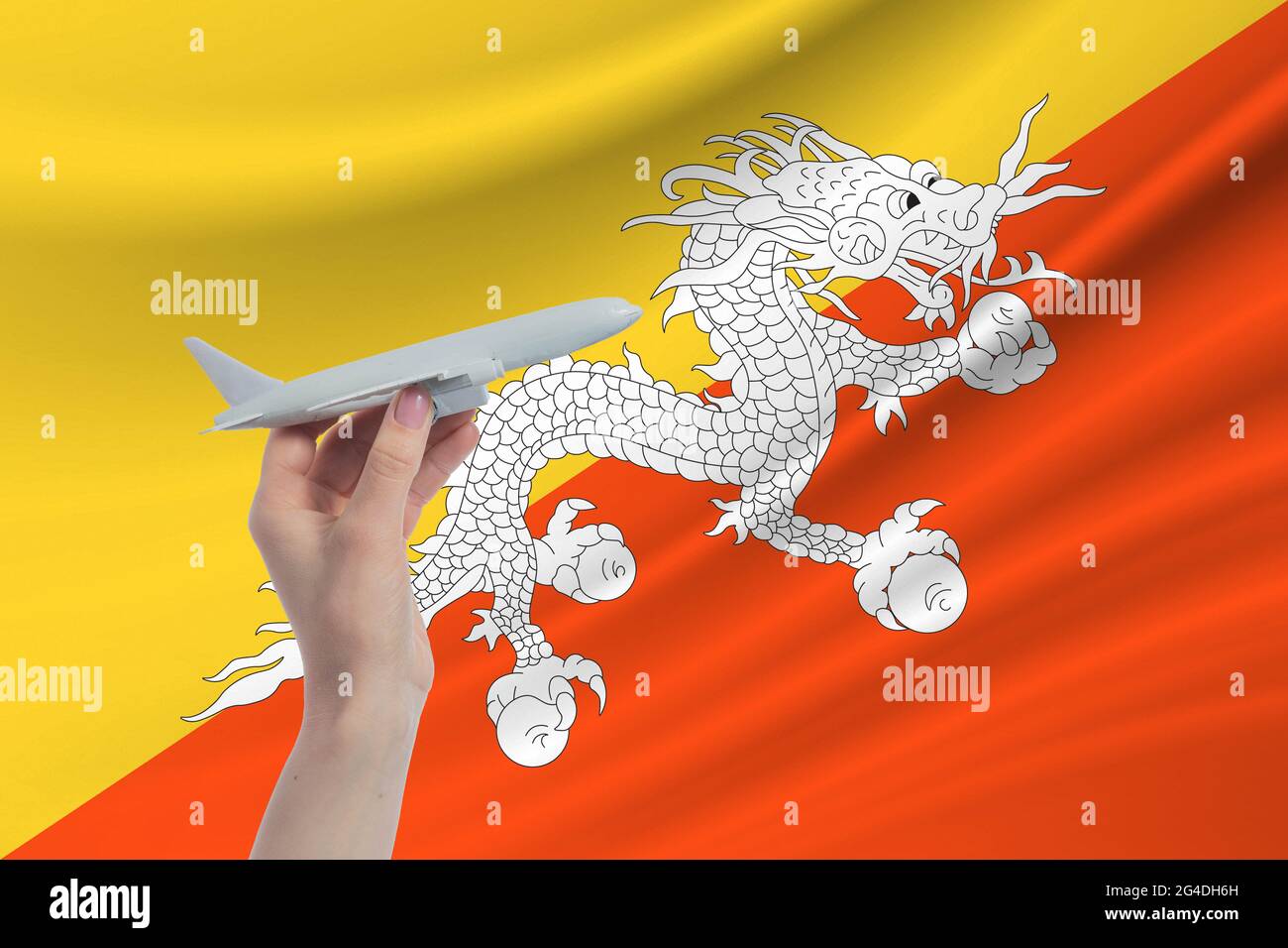 Airplane in hand with national flag of Butane. Travel to Butane Stock Photo Alamy