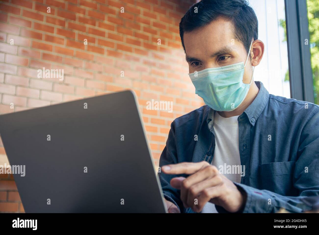 Man work freelance in cafe by laptop computer, People wear face mask ...