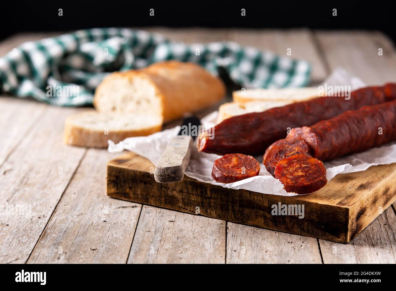 Spanish chorizo sausage on rustic wooden table Stock Photo - Alamy