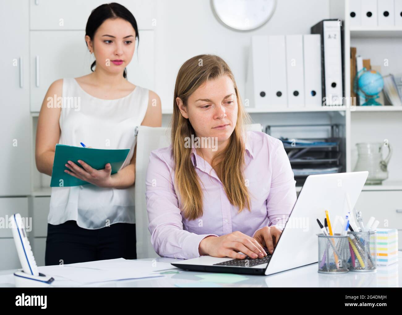 Manager inspecting work Stock Photo - Alamy