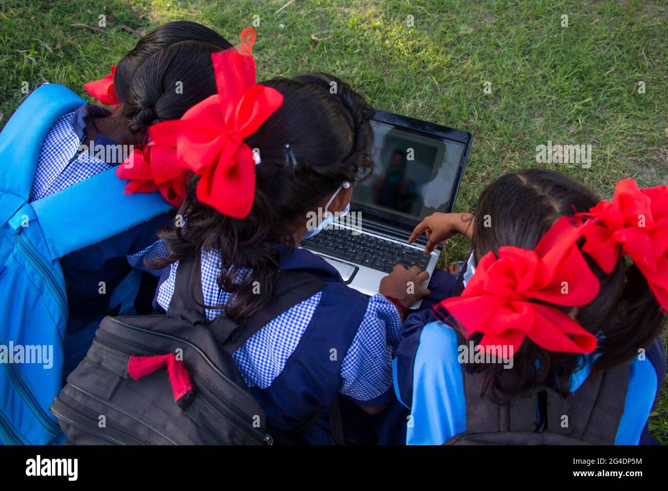 Back View indian village government school girls operating laptop