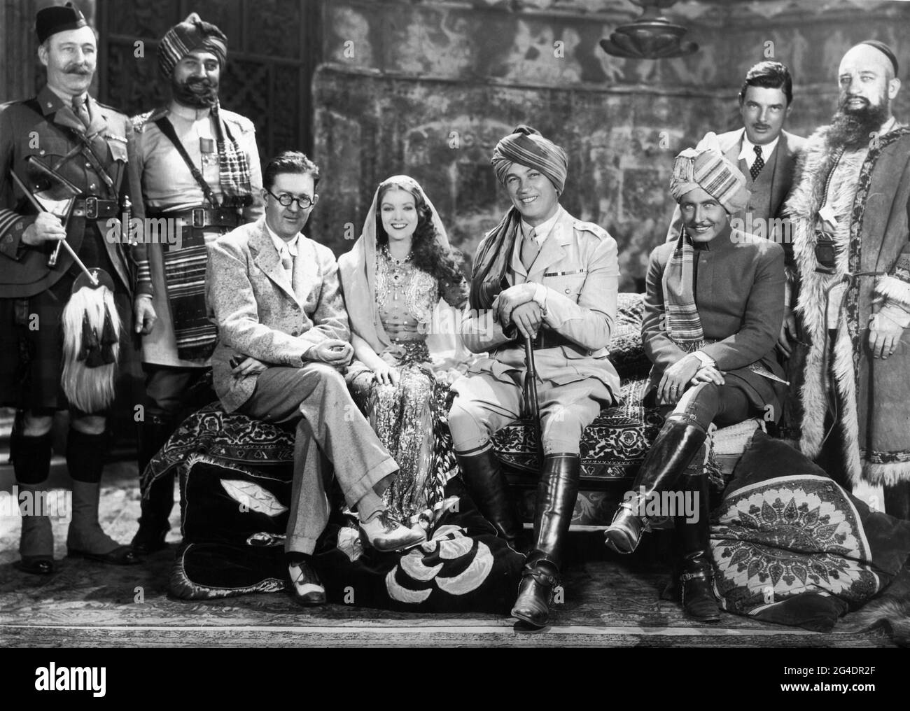 LUMSDEN HARE possibly MITCHELL LEWIS Director JOHN FORD MYRNA LOY VICTOR McLAGLEN ROY D'ARCY Assistant Director WINGATE SMITH and WALTER LONG on set candid group photo taken during filming of THE BLACK WATCH 1929 director JOHN FORD from novel King of the Khyber Rifles by Talbot Mundy Fox Film Corporation Stock Photo