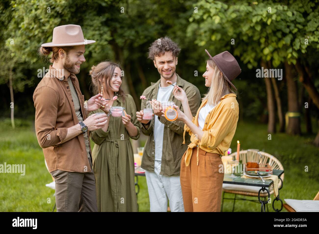 Friends with ice cream gathering outdooors Stock Photo