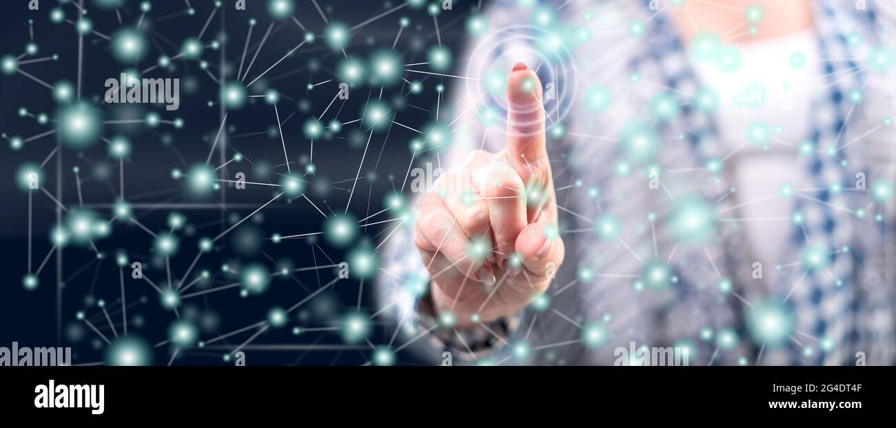 Woman touching a virtual network on a touch screen with her finger ...