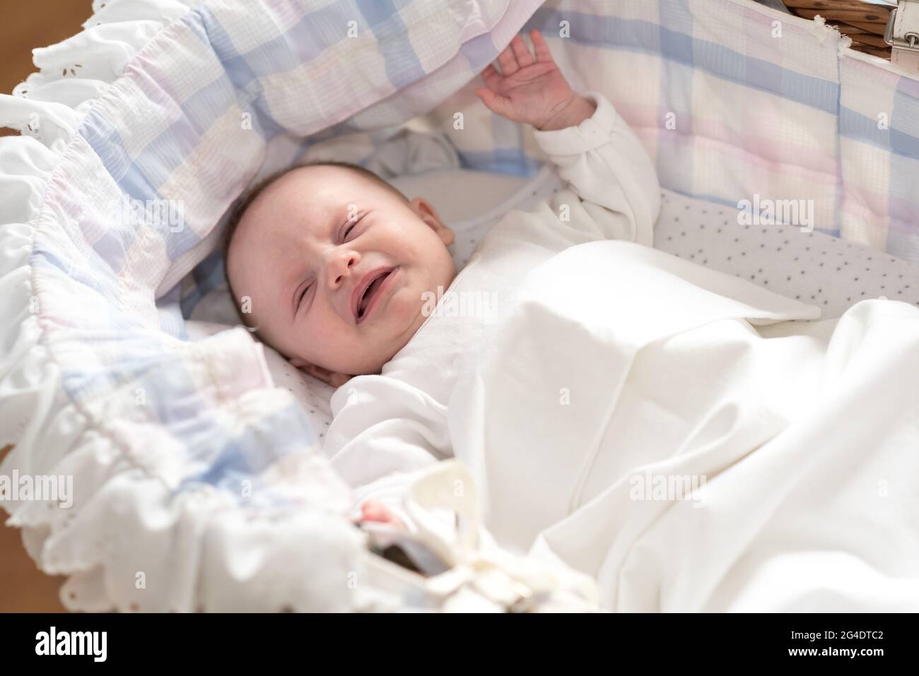 Little baby girl crying in her crib Stock Photo Alamy