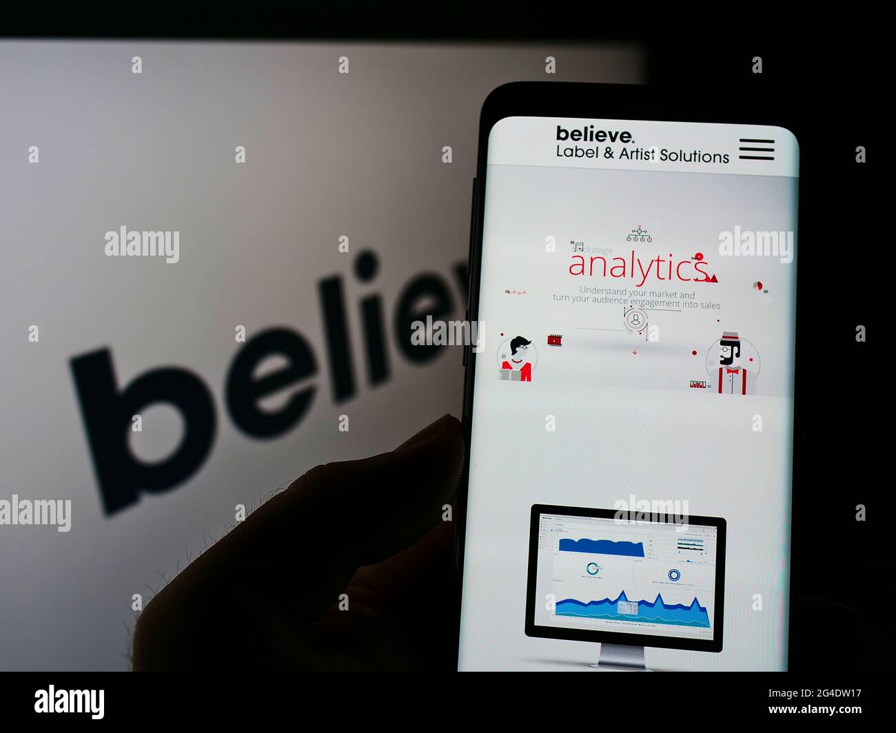 Mobile phone with website of French record label Believe Digital on screen  in front of business logo. Focus on top-left of phone display Stock Photo -  Alamy
