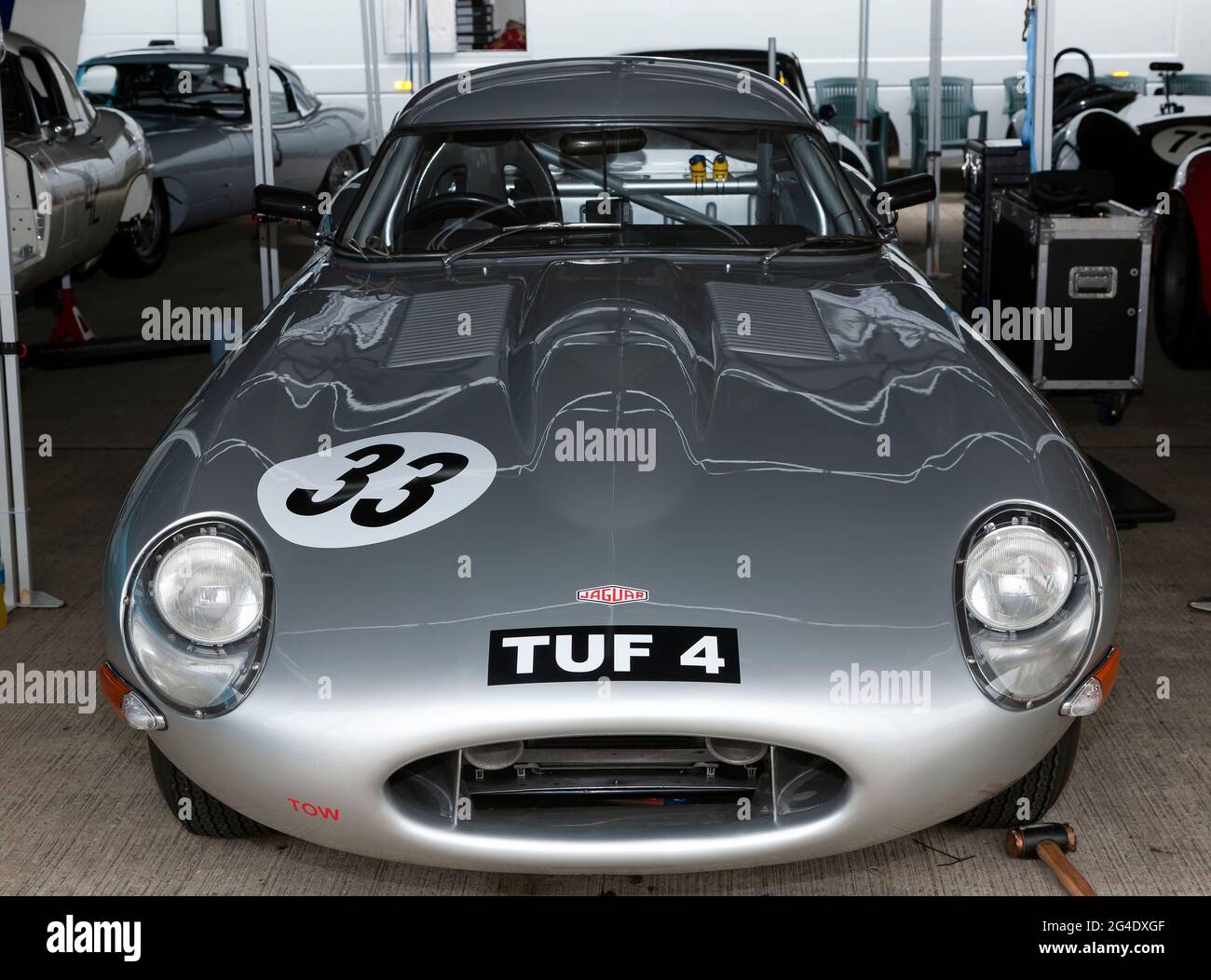 Front view of Hans Huebners'  Silver, 1963, Jaguar E-Type, in the International Paddock, during the 2017, Silverstone Classic Stock Photo