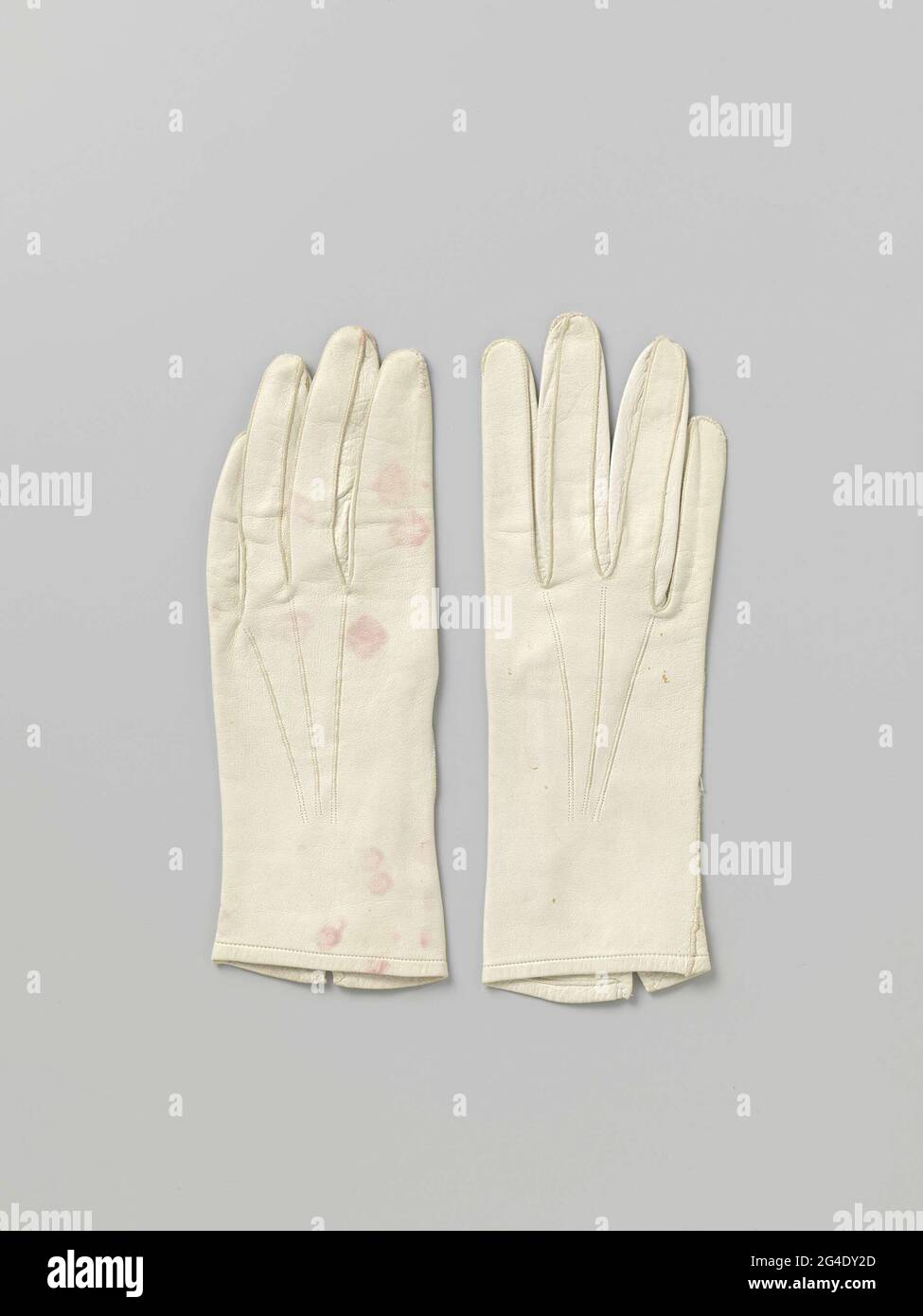 . Left glove from white leather. Closure with copper snap button