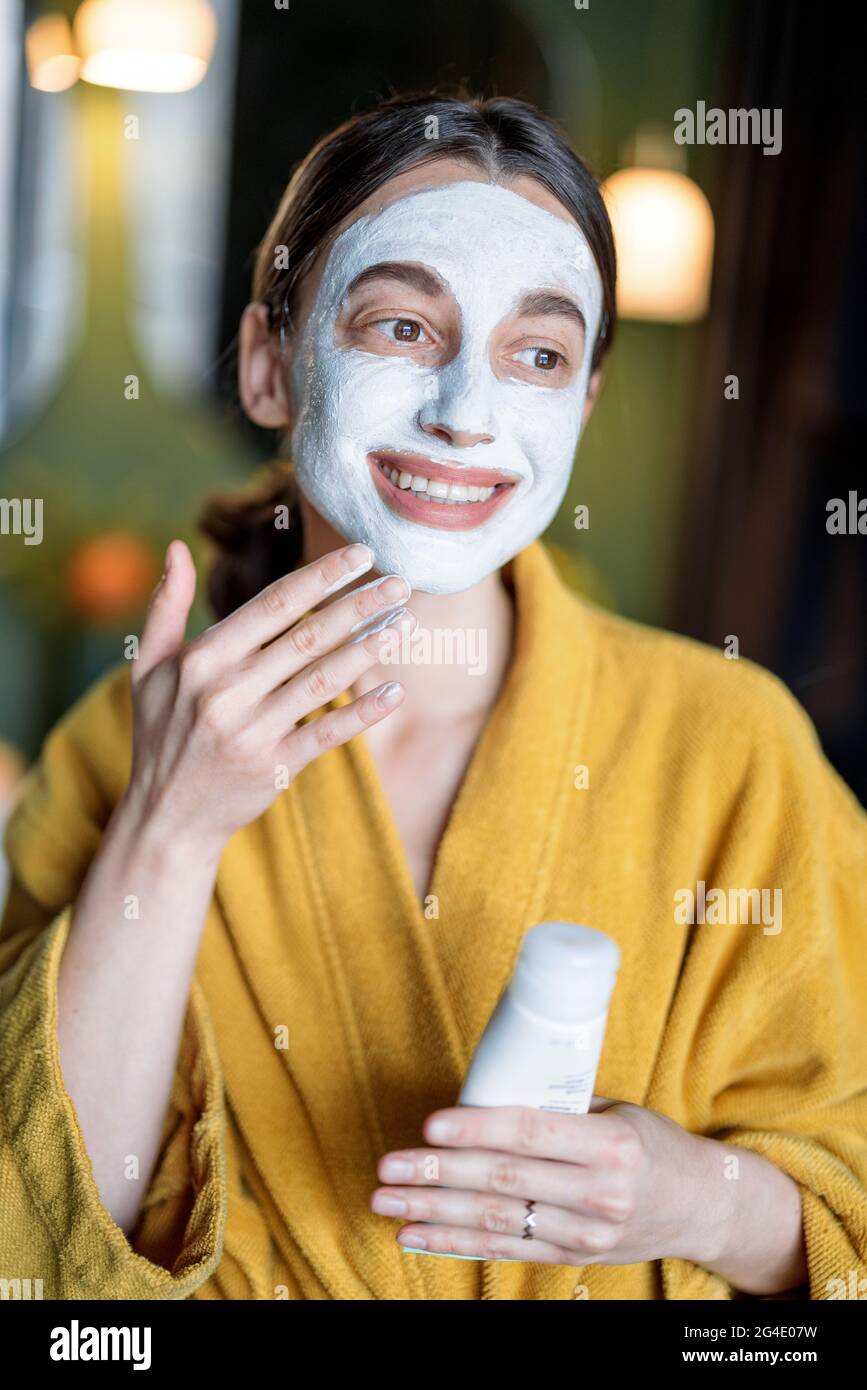 Young woman applies cleansing mask hi-res stock photography and images ...