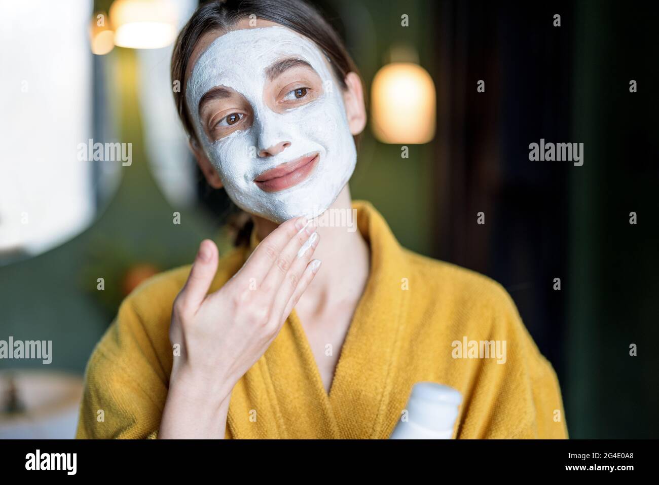 Young woman applies cleansing mask hi-res stock photography and images ...