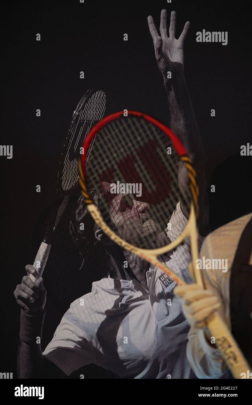 A Christie's technician holding one of Roger Federer's tournament ...