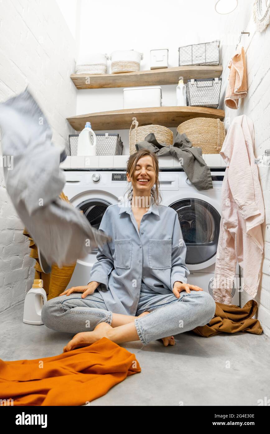 Housewife throwing up clothes at the laundry Stock Photo Alamy