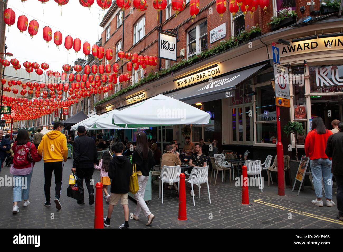 London, UK, 20 June 2021: the streets of Chinatown are busy with customers and despite cloudy weather many people prefer to eat outdoors. Anna Watson/Alamy Stock Photo
