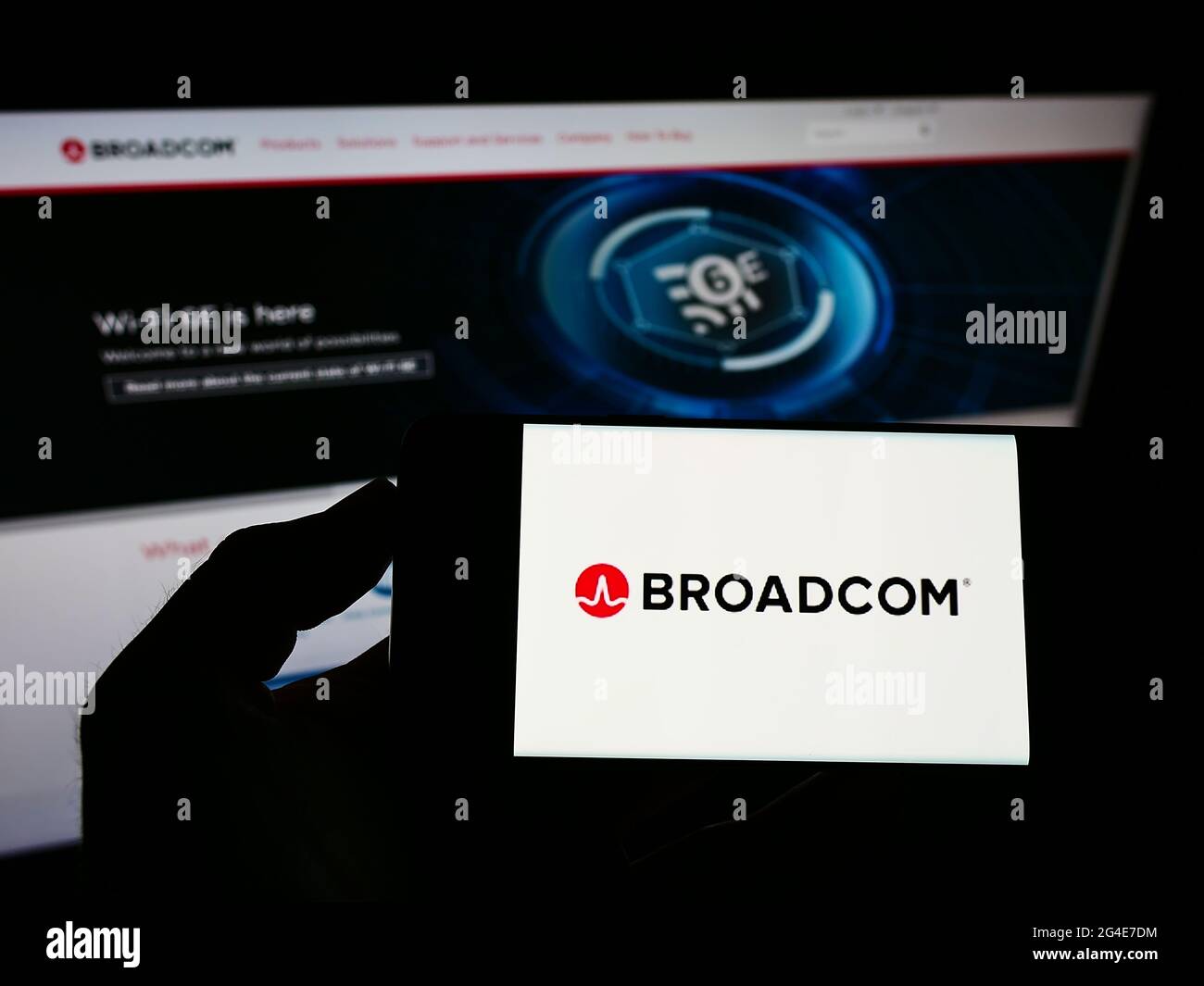 Person holding smartphone with logo of US semiconductor company Broadcom  Inc. on screen in front of website. Focus on phone display Stock Photo -  Alamy