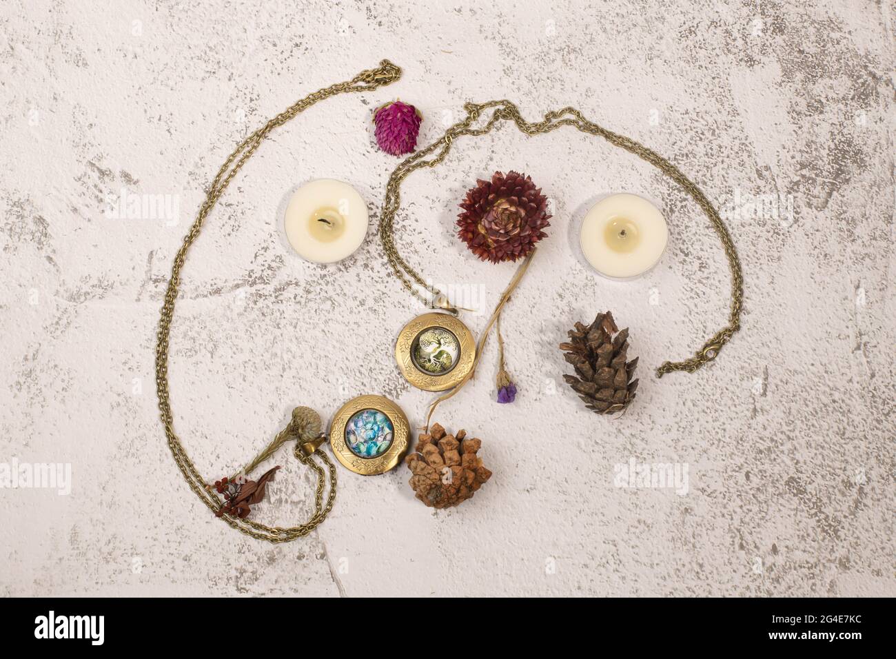 Flatlay with medallion, candles and dried flowers Stock Photo