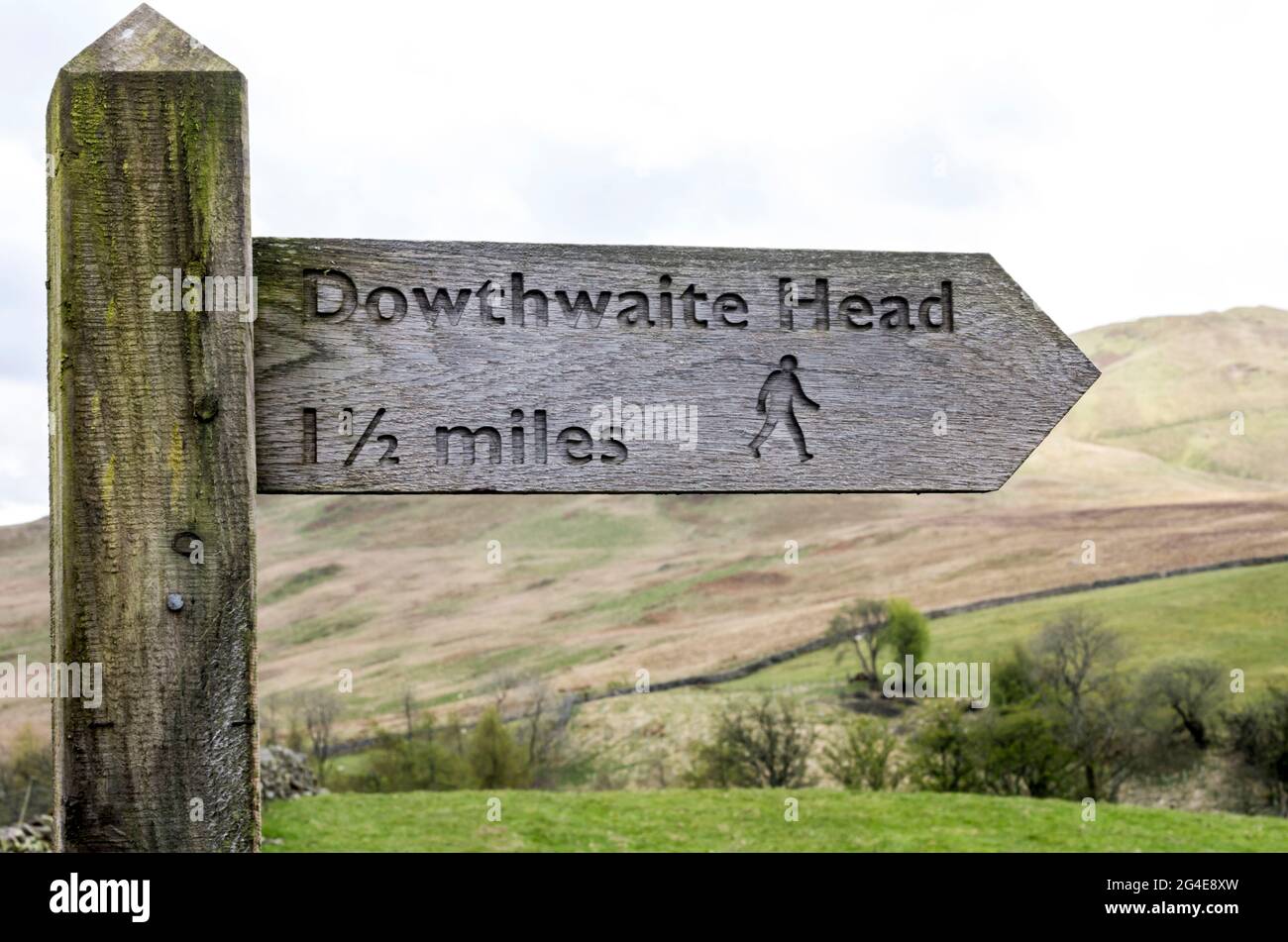 A wooden signpost in the Lake District, Cumbria, UK pointing to Dowthwaite Head. Stock Photo